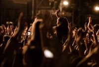 crowd-people-with-raised-arms-having-fun-music-festival-by-night