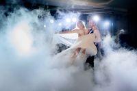 groom-whirls-bride-smoke-dancing-first-time