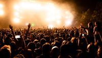 rear-view-large-group-music-fans-front-stage-during-music-concert-by-night-copy-space